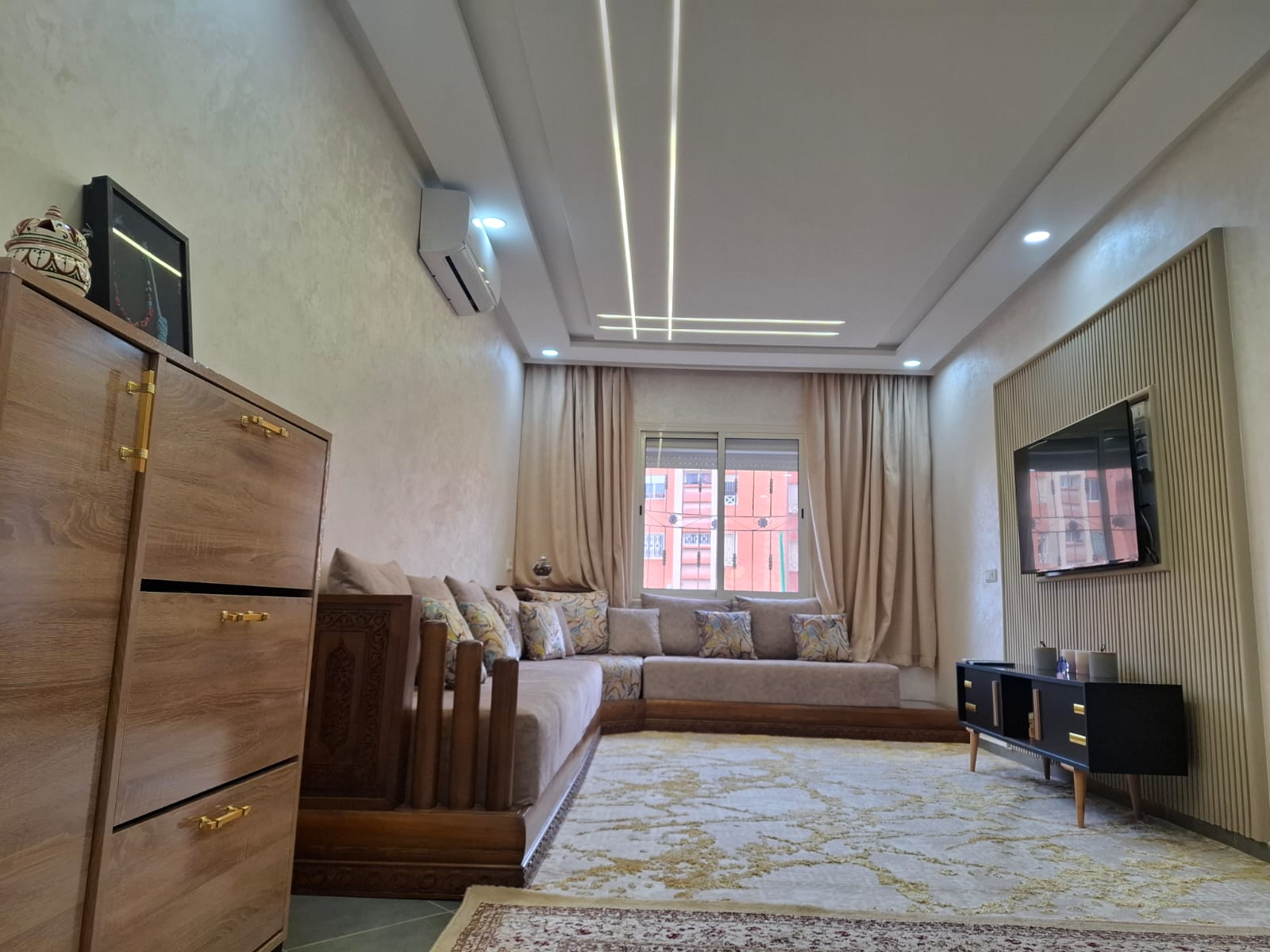 Wide living room view with seating and TV.